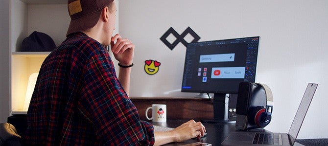guy sitting at a desk working on his computer